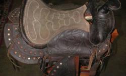 Aussie Stock Saddle for sale. Lightly used to train young horses. The two 'ears' keep you seated while running, etc. Includes stirrup irons & girth strap.