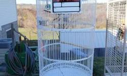 Ornamental Antique Cage. 1" heavy bar spacing for the BIG birds. Very large front door with 3 latches for secure closure. Measures 90" around and 72" tall. Inside wing span is 30" Includes perch, swing, SS dishes, 2 clean out trays. Access to dishes from