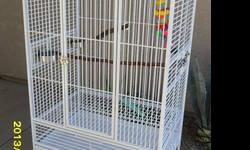 Huge HQ Double macaw/cockatoo cage... in the sand colored powdercoat... Great condition... 68" across x 34" deep and 70" tall... middle divider for one HUGE cage or two Good sized cages... 4 stainless bowls and natural perches included... $350 call for