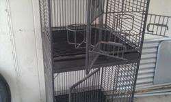 Heavy Duty. double stack, steel parrot cage on wheels. 59" tall, each cage is 26" T x 24" W x 24" D . front door/ 2 feeder doors/ nest box door.( IF YOUR READING THIS AD, THEN CAGE IS STILL AVAILABLE) CALL or TEXT. 602 425 3300