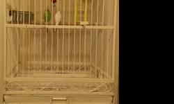 I have a large bird and/or parrot cage. I believe it was originally made for a parrot. Includes two parakeets living inside the cage. One male and one female. Male is greenish blue, and female is solid white. Cage is on wheels and stands about 6 feet tall