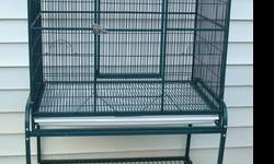 Green like new double flight cage with removable divider. Removable pull out grates and trays. Shelf under cage. Cage lifts off rolling stand. 65W X 21D X 36H x 62 H with stand. Clean and ready to go.